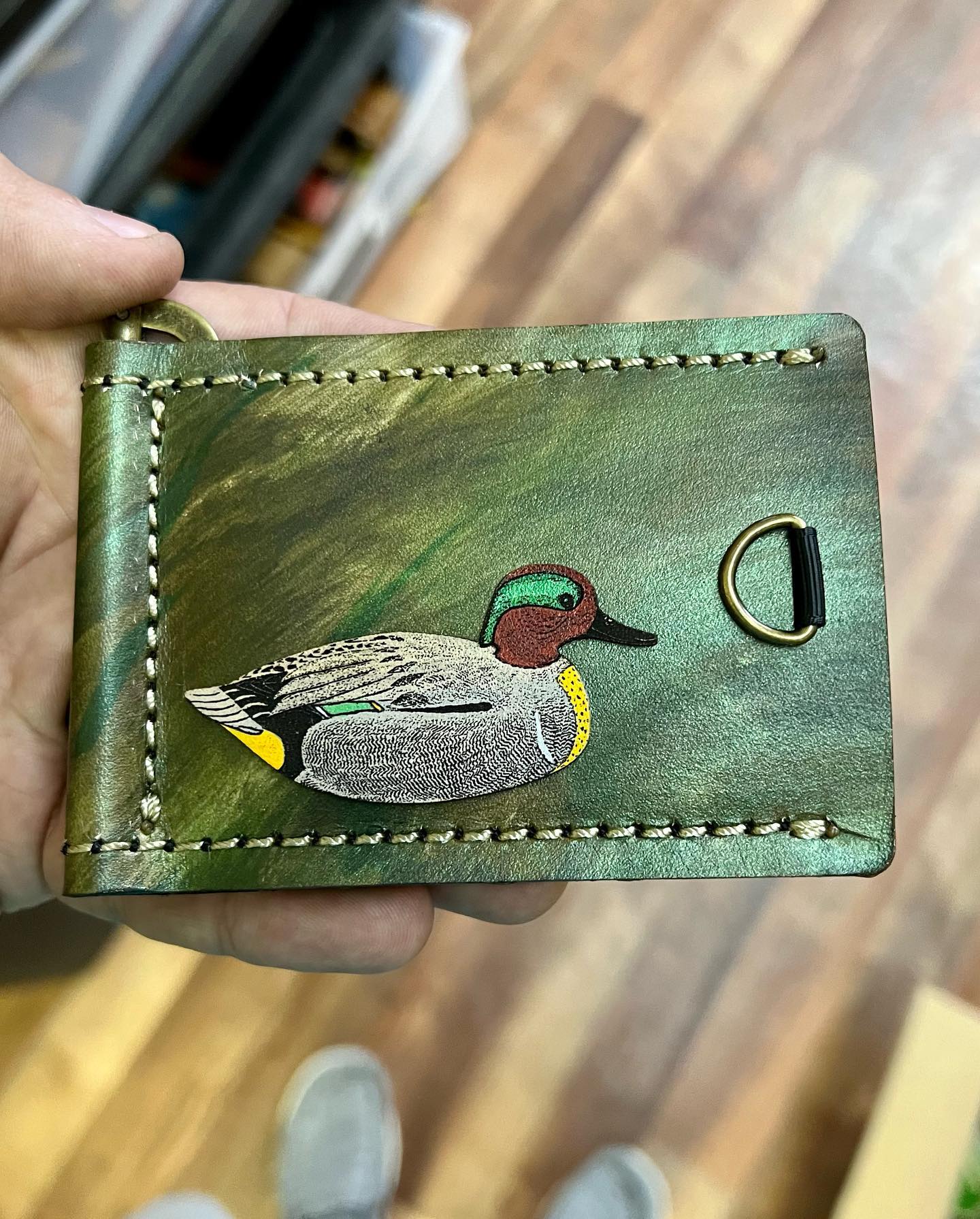 A full sheet of stamped Red River Leather tags and fish-shaped leather patches.