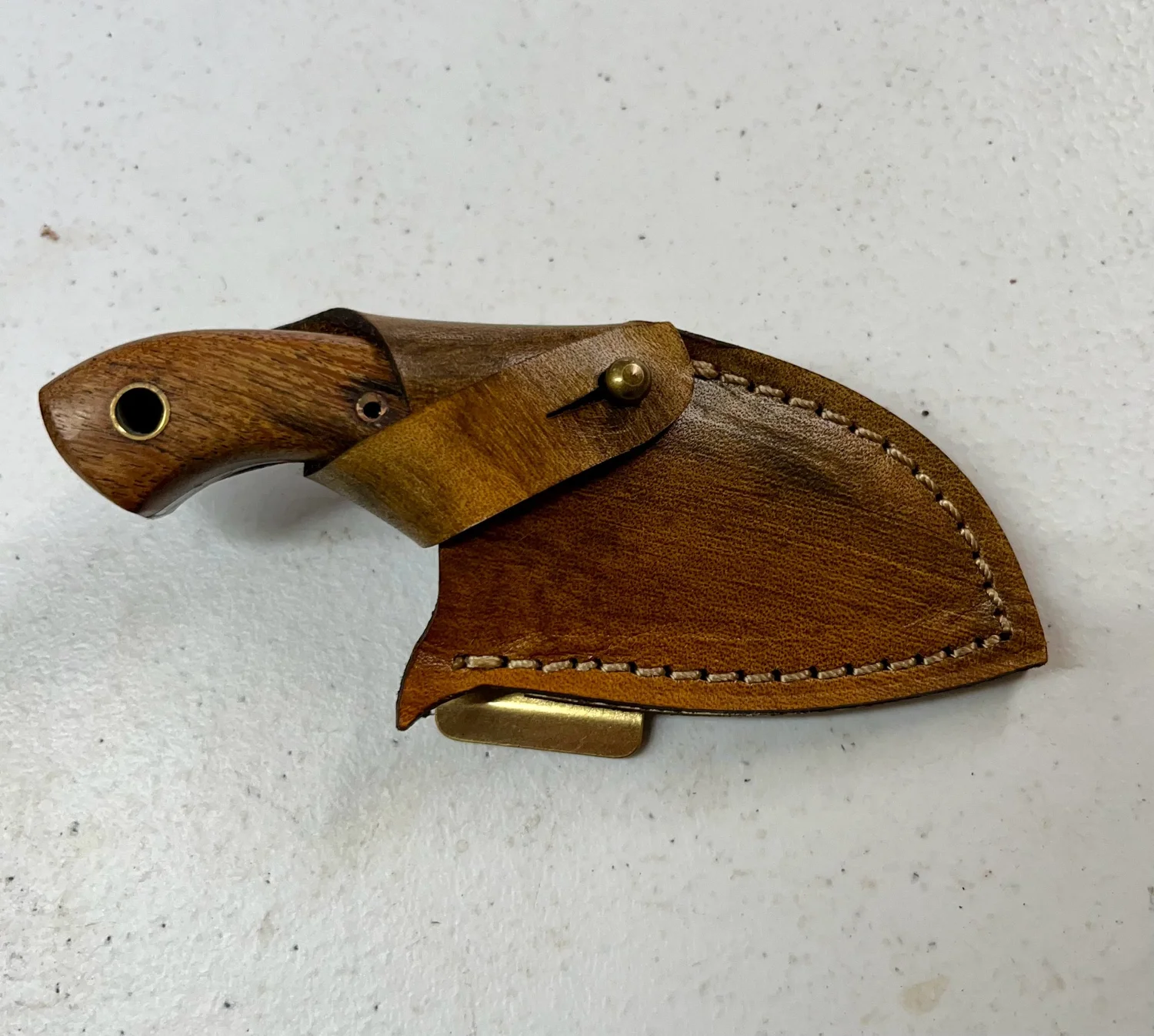 Clip-on knife with handmade leather sheath.